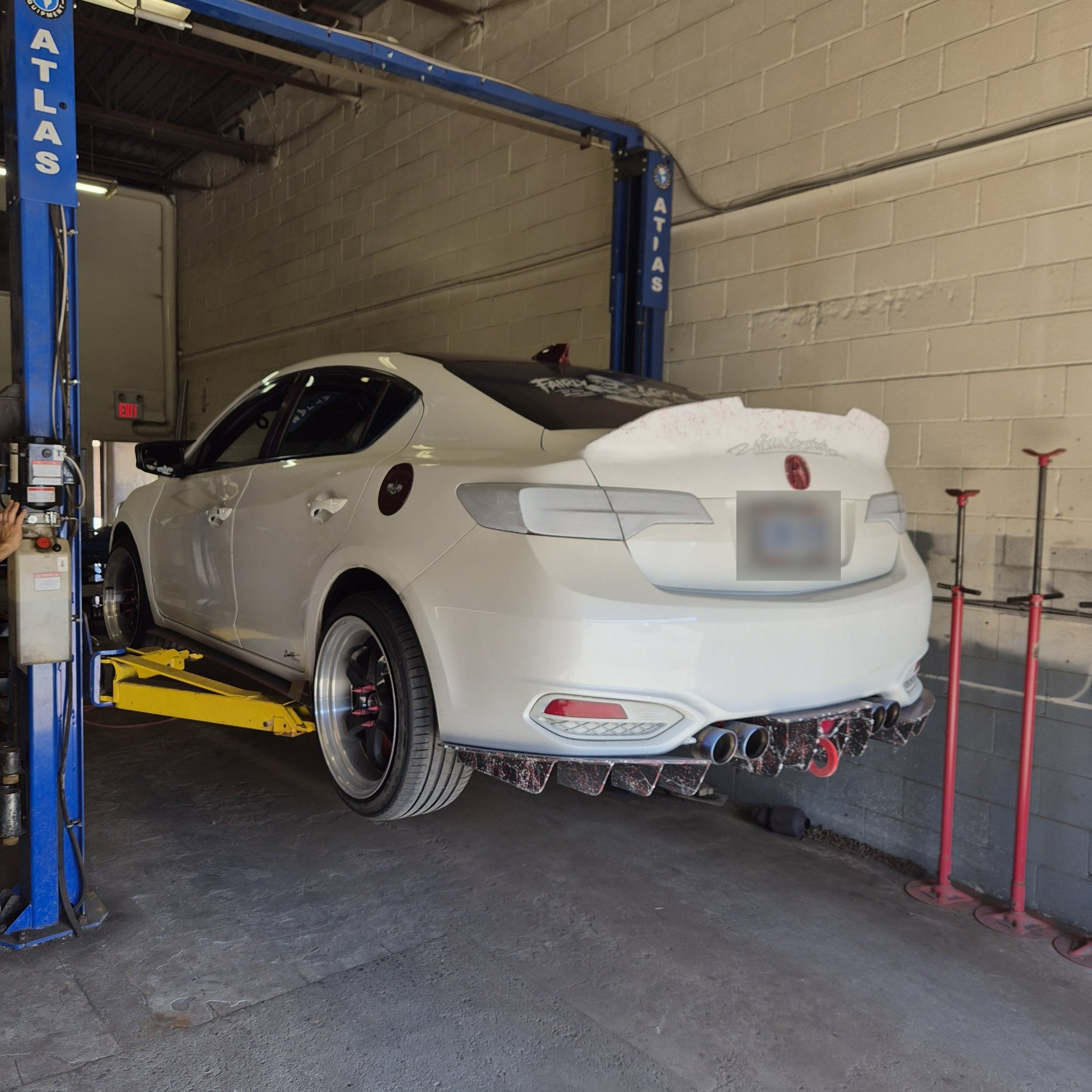 Rear three-quarter view of the Acura custom diffuser and quad exhaust