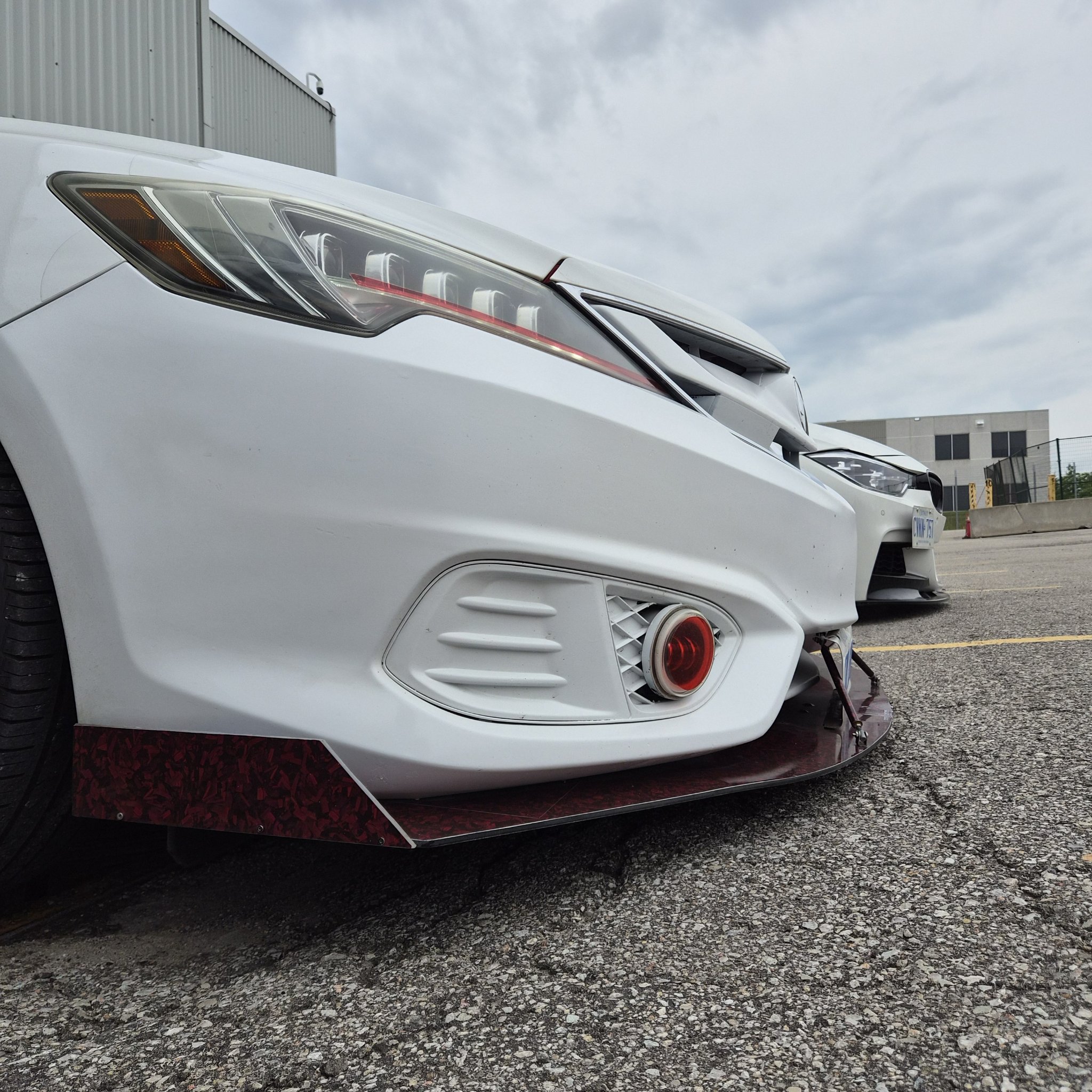 Close-up of the Acura custom front lip and red splatter finish