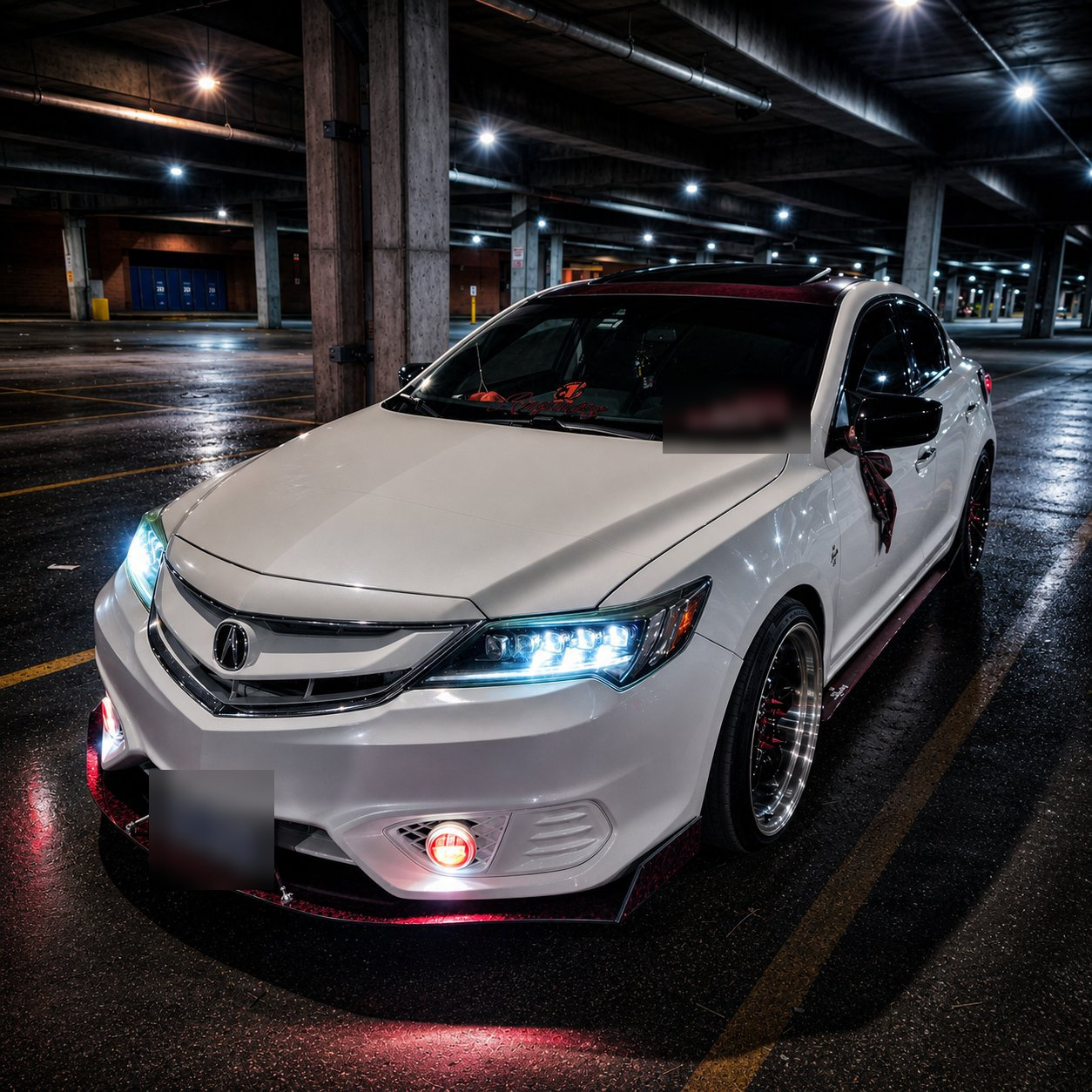 White Acura and custom front lip in a wet parking garage at night