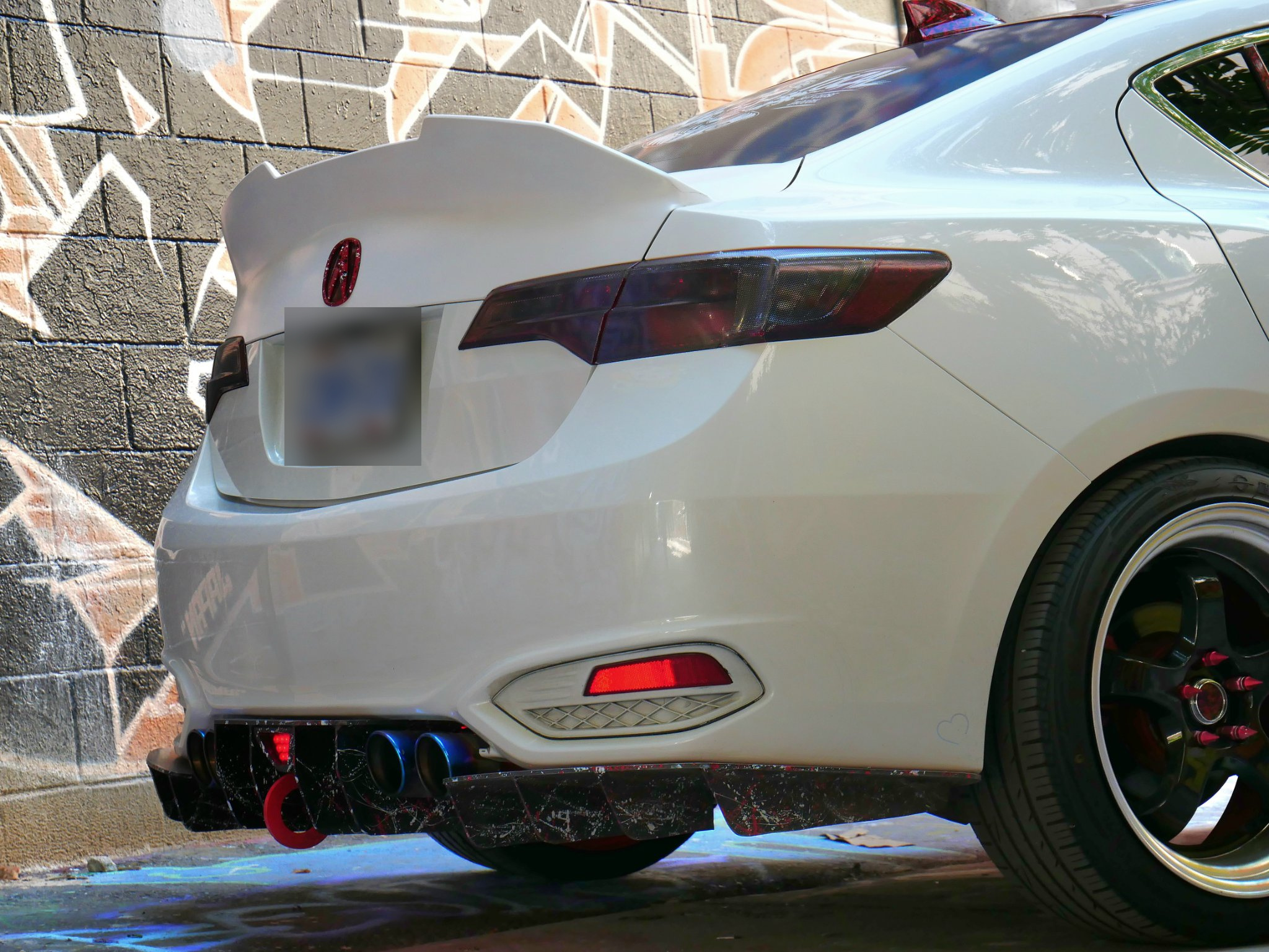 Low rear three-quarter view showing the diffuser fins