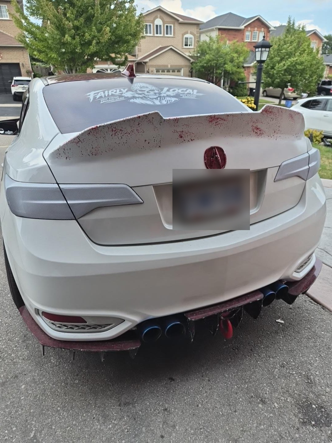 Finished molded duckbill spoiler on the white Acura