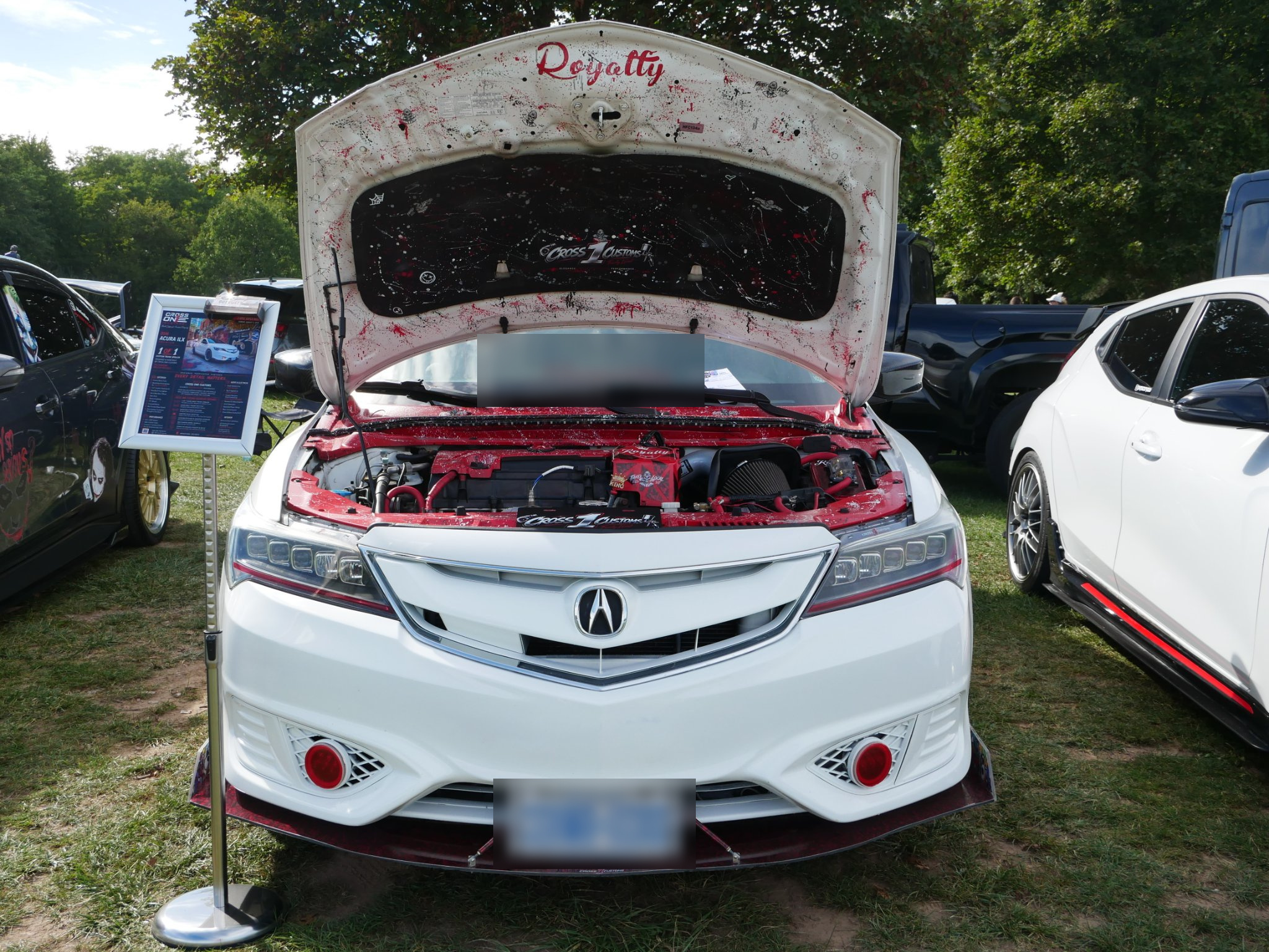 Front view of the Acura Royalty red and black splatter-painted engine bay