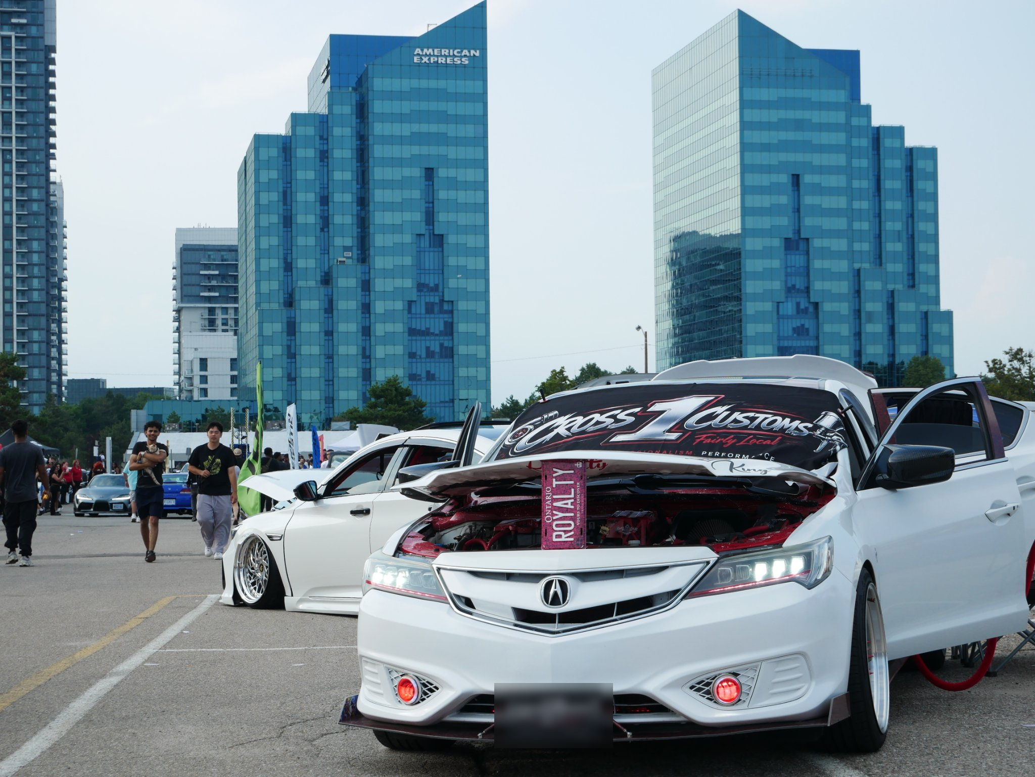 White Acura displaying its custom front lip at a car show