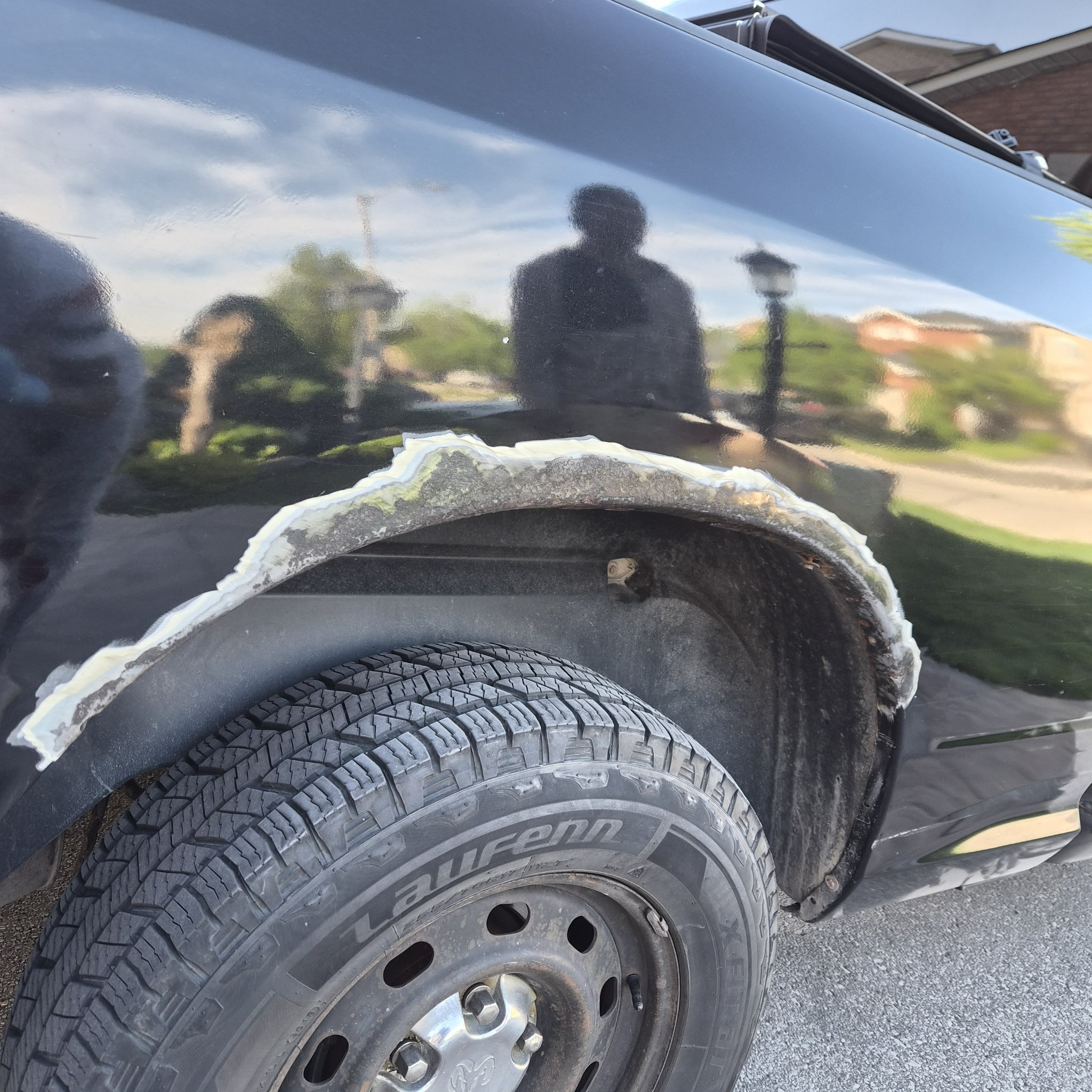 White filler applied over prepared metal around the Ram rear wheel arch