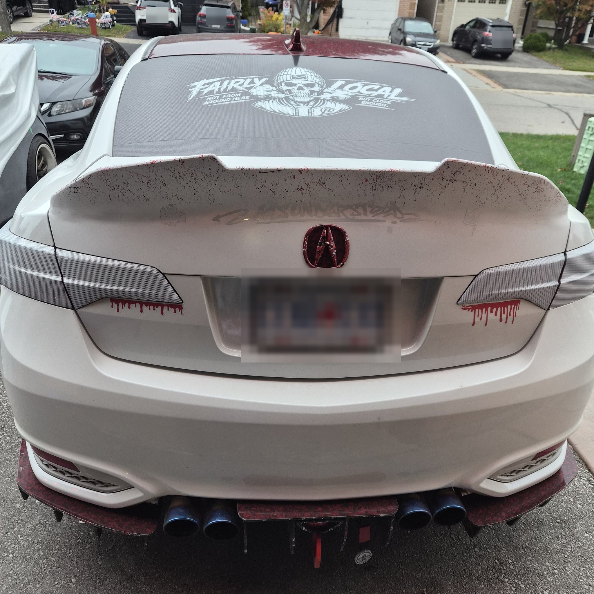 Full rear view of the white Acura showing the molded duckbill spoiler and custom rear diffuser