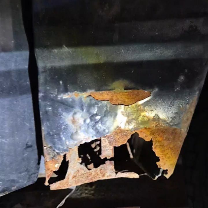 Close-up of a heavily corroded automotive body panel