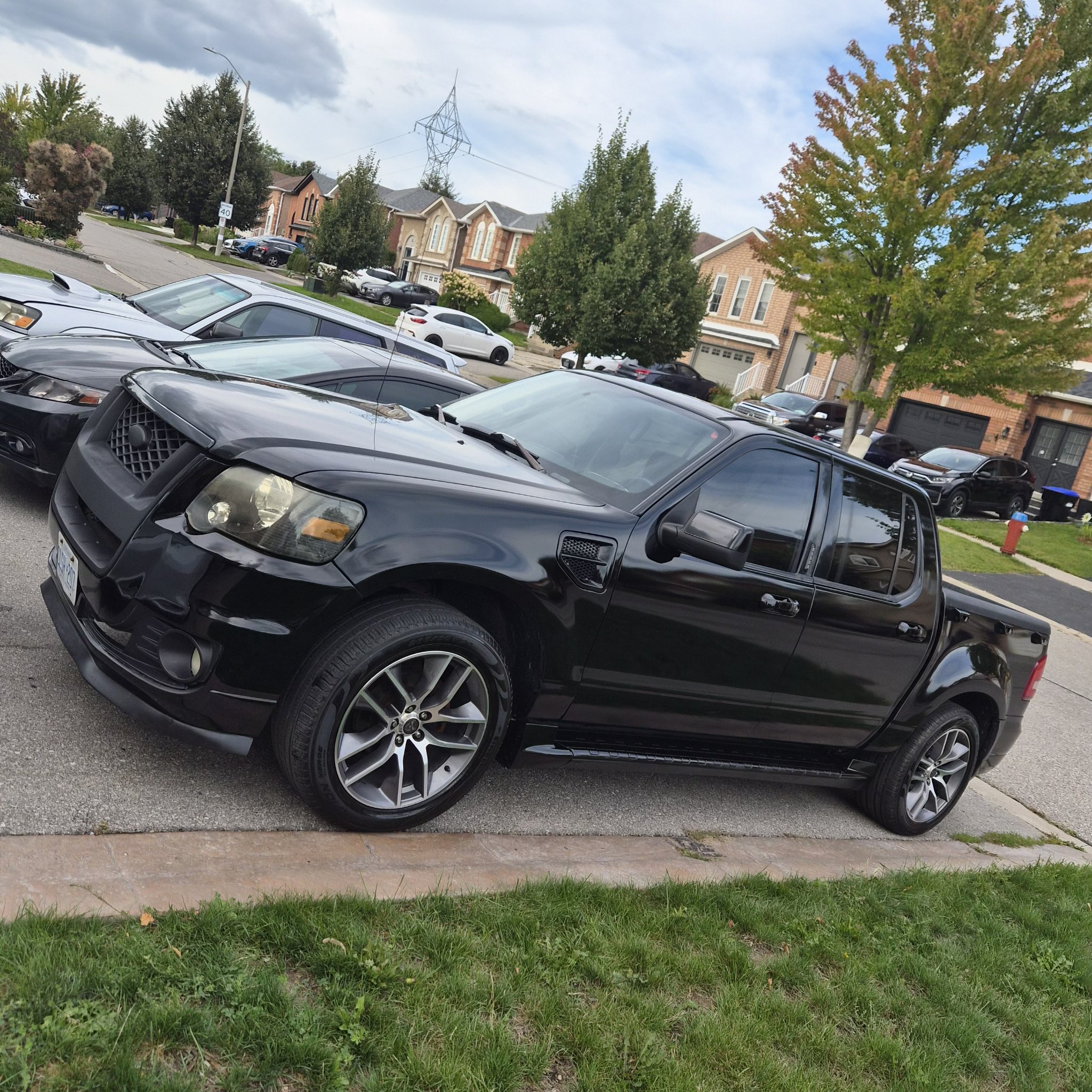 Finished glossy black Ford Explorer Sport Trac parked on the street